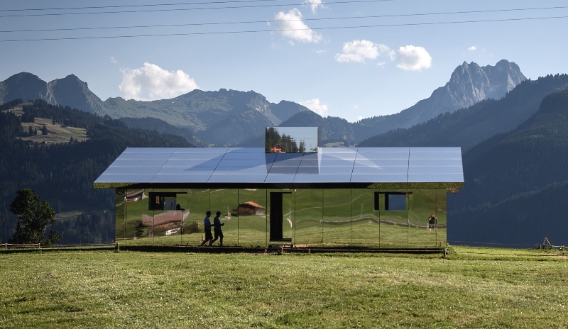 Mirage Gstaad", a sculpture by Los Angeles-based artist Doug Aitken representing a chalet made with mirrors reflecting the Alpine landscape of the Berner Oberland area in Schonried near Gstaad, Switzerland. AFP