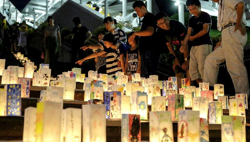 People lighting lanterns for atomic bomb victims to mark the 73rd anniversary of the bombing at Peace Memorial Park, Nagasaki, in 2018. AFP