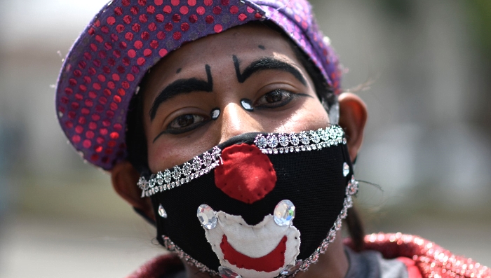 A clown wearing a face mask poses for a picture during a protest by artists from at least 30 circuses economically affected by the coronavirus lockdown restrictions outside the Culture Palace in Guatemala City. AFP