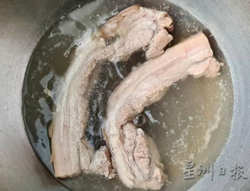 水里加入绍兴酒煮熟三层肉，再加盐腌制一夜后煎香，散发微微酒香的咸猪肉，难以抗拒。