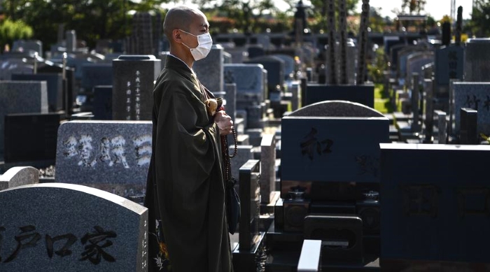 Yogetse Akasaka posing at a cemetery after a religious ceremony in Shimoshizu, Chiba prefecture. AFP