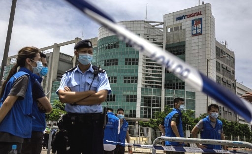 Police cordon off the area outside the Next Media publishing offices after the company's founder Jimmy Lai was arrested under the national security law. AFP
