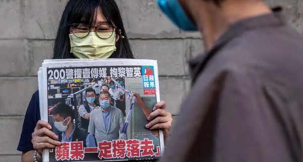 Hong Kongers buy copies of Apple Daily and shares in its parent company to show support for its arrested owner. AFP