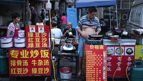 A man selling food on a street in Wuhan. AFP