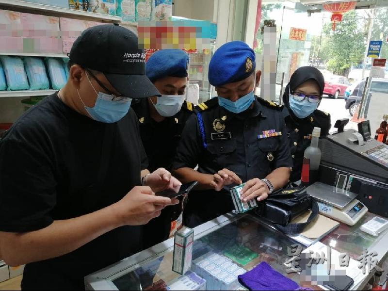 执法人员接获有商家售卖赝品投报,前往商店展开取缔行动。(图由甲贸消局提供)