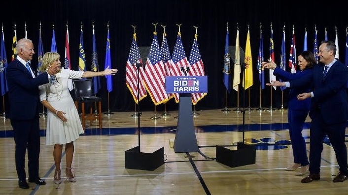 Biden (L) with his wife Jill gesture with Harris and her husband Douglas Emhoff. AFP