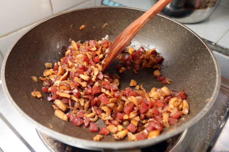 虾米、小红葱、冬菇及腊肠一起炒香，取出备用。