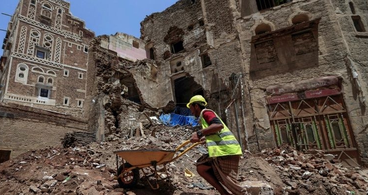 Laborers remove rubble ahead of restoration works on the site of a collapsed UNESCO-listed building following heavy rains in the Old City of Sanaa. AFP