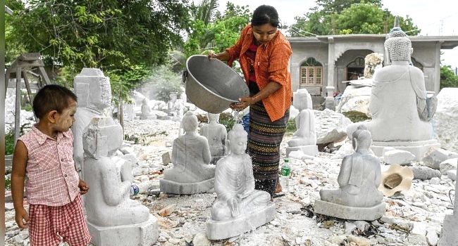 Faces covered in white dust and chisels in hand, marble sculptors in Myanmar say the hills that have given them a livelihood for generations are disappearing. AFP