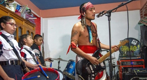 Victor Hugo Sandoval, vocalist and guitarist of rock band Los Cogelones, rehearses with his students in Ciudad Nezahualcoyotl. AFP
