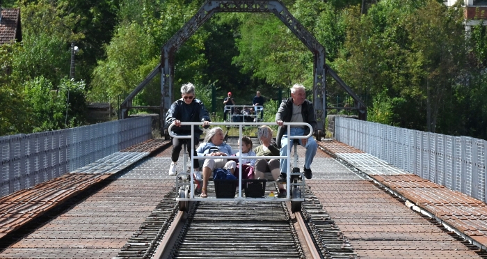 People crossing the Viaduc des Fades as they ride the 'vélorail' on an old railway line in Les Ancizes-Comps in central France. AFP