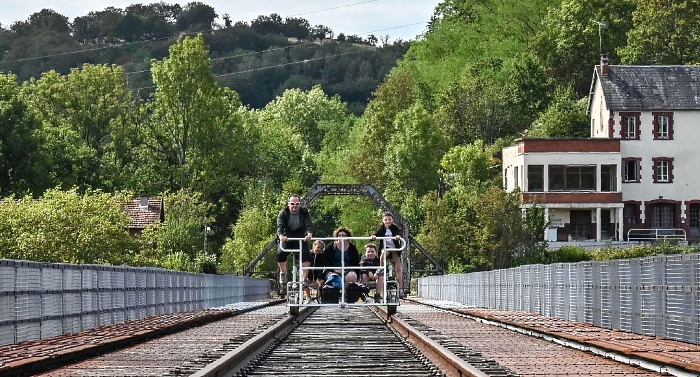 People crossing the Viaduc des Fades as they ride the 'vélorail' on an old railway line in Les Ancizes-Comps in central France. AFP