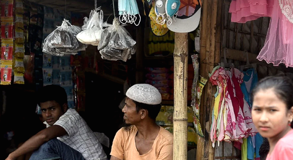 A Rohingya shopkeeper sells face mask in Kutupalong refugee camp near Ukhia. AFP