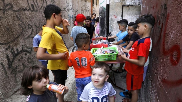 Palestinian children gather around a street vendor in the Amari refugee camp near the West Bank city of Ramallah. AFP Palestinian children gather around a street vendor in the Amari refugee camp near the West Bank city of Ramallah. AFP