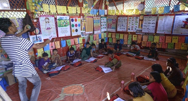 Rohingya children attend a lesson to learn their language at a school at Jamtola refugee camp in Ukhia. AFP