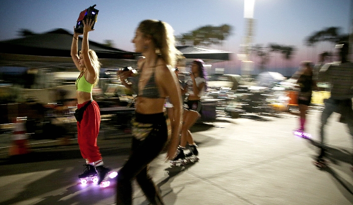 People roller skating along the Venice Beach boardwalk in Venice, California, during the coronavirus pandemic in search of outdoor activities amidst lifestyle restrictions due to the virus. AFP People roller skating along the Venice Beach boardwalk in Venice, California, during the coronavirus pandemic in search of outdoor activities amidst lifestyle restrictions due to the virus. AFP