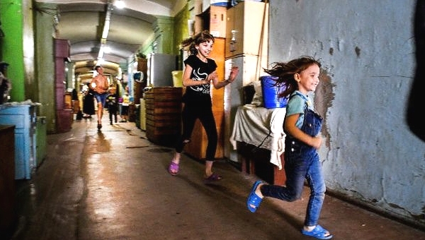 Children play in the long corridors to escape the crampness of their living quarters. AFP Children play in the long corridors to escape the crampness of their living quarters. AFP