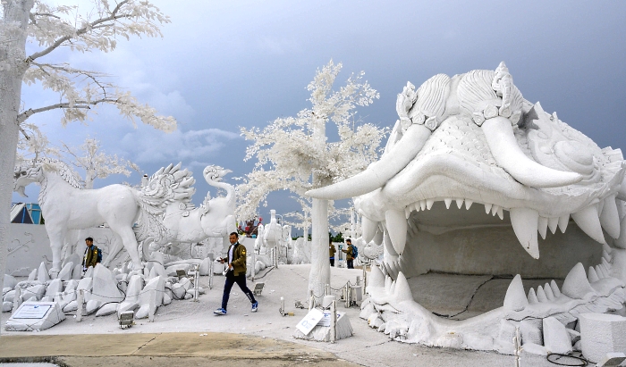 Visitors taking pictures in front of sculptures made of white sand imitating ice in the "Frost Magical Ice of Siam" park outside Pattaya, Thailand. AFP Visitors taking pictures in front of sculptures made of white sand imitating ice in the "Frost Magical Ice of Siam" park outside Pattaya, Thailand. AFP