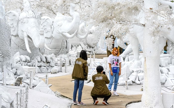 Visitors taking pictures in front of sculptures made of white sand imitating ice in the "Frost Magical Ice of Siam" park outside Pattaya, Thailand. AFP Visitors taking pictures in front of sculptures made of white sand imitating ice in the "Frost Magical Ice of Siam" park outside Pattaya, Thailand. AFP