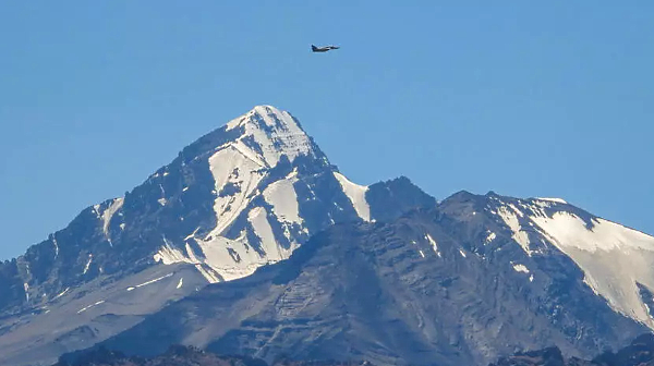 An Indian fighter flies over mountains near the border with China. AFP