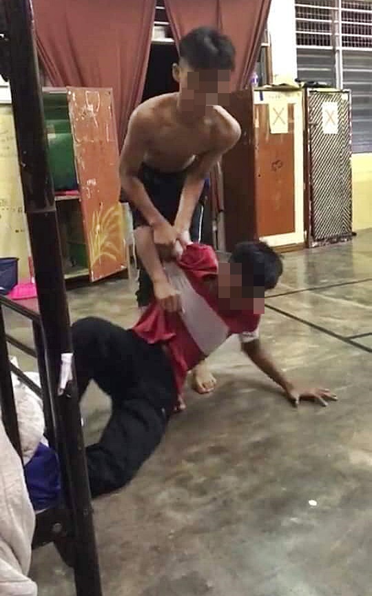 其中一名上半身赤裸的学生，对受害学生拳打脚踢。