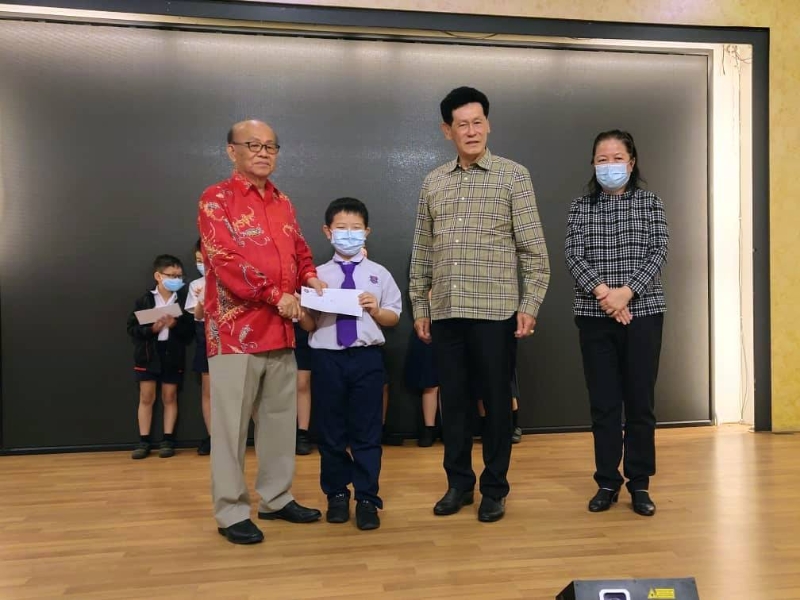 陈展鹏（左一）分发奖励金给中国公学获奖学生，右起为刘美香及苏亚龙。
