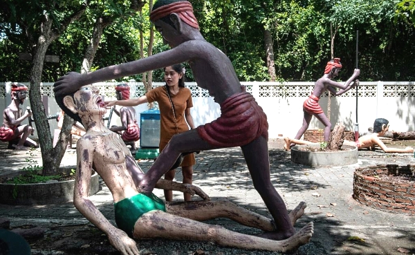 Wat Saen Suk allows visitors to wander through a garden of graphic tableaus of punishment and torture. AFP