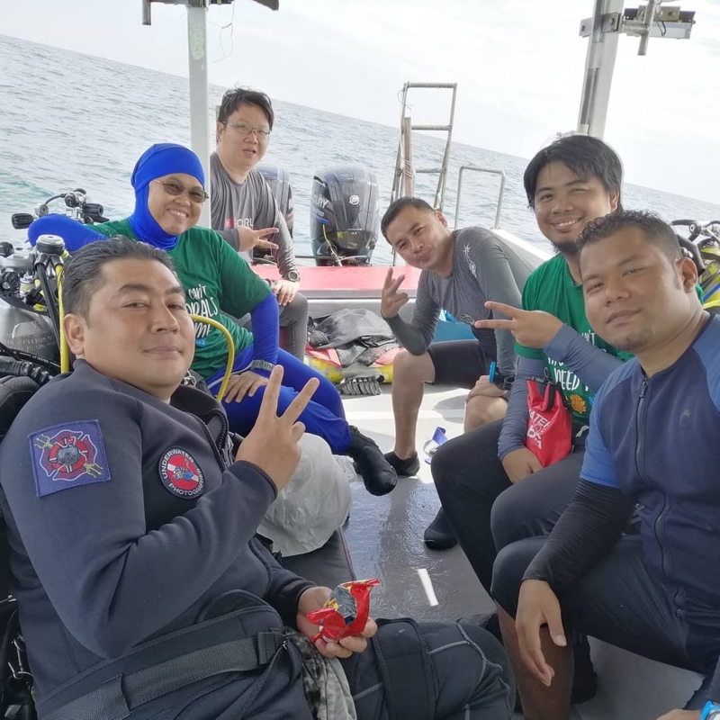 在渔业发展局安排下，陈思宇(左三)与潜水好友一同出海，展开清除“鬼网”的任务。