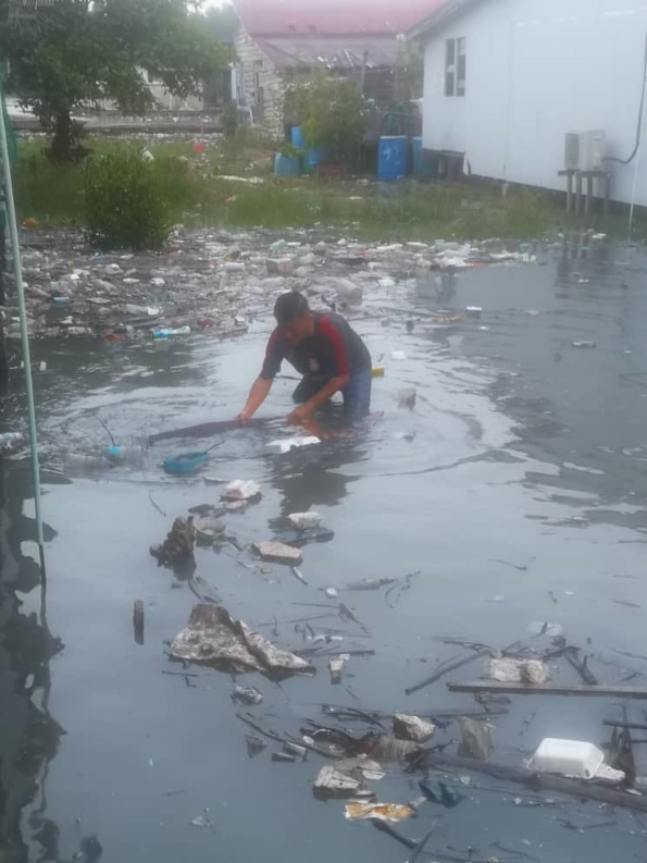 五条港居民趁海潮后捞取垃圾。