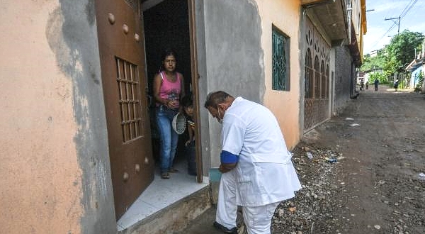 A health worker goes door-to-door looking for people with coronavirus symptoms in Tlapa de Comonfort in the southern state of Guerrero. AFP