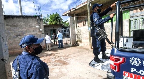 Armed police accompany the health workers as they visit homes. AFP