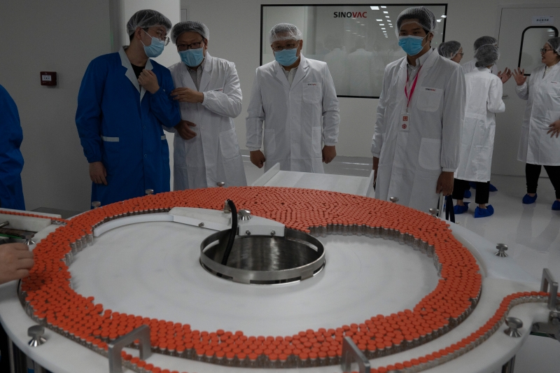 在北京科兴生物制品公司的厂房，公司人员为访客介绍冠病疫苗CoronaVac生产。（图：美联社）