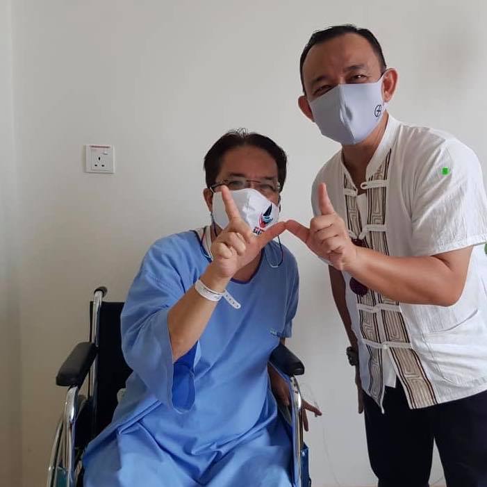 刘伟强（左）与马智礼一同比出沙巴民兴党的手势“W”合影，看起来精神状况良好。