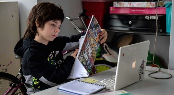 Young Francisco Pergola is one of the lucky Brazilian kids: he has internet access and a laptop to take online classes at home. AFP