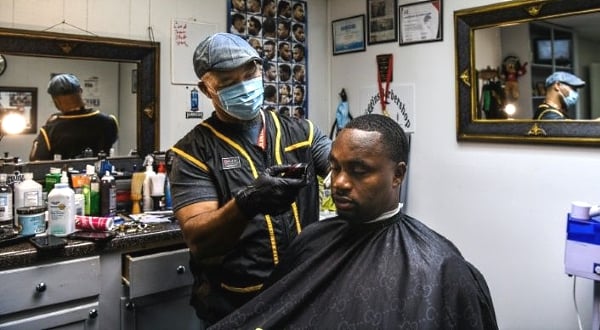 Antonio Wiggins (L) cuts the hair of James Bennett at his barber shop in Jackson, Mississippi. AFP