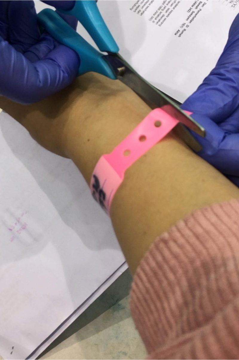 林文荪贴出医护人员帮她剪断粉红色隔离手环的照片，宣布“出关”了。