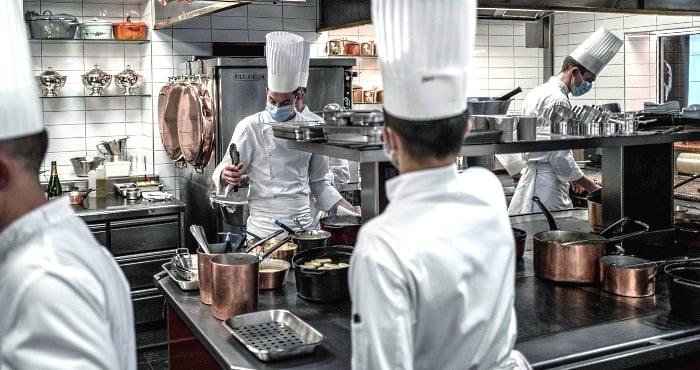 Chefs and cooks prepare frog legs in Paul Bocuse's restaurant 