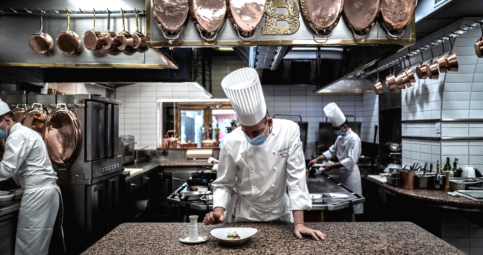 French chef Gilles Reinhardt prepares frog legs in Paul Bocuse's restaurant 