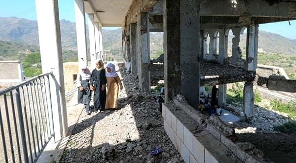 Pupils head to class on the first day of the new academic year in their school in Taez heavily damaged in an air strike two years ago. AFP