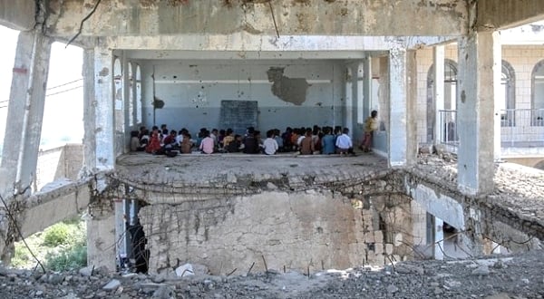 Pupils attend class on the first day of the new academic year in their school in Taez heavily damaged in an air strike two years ago. AFP