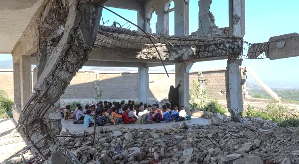 Pupils attend class on the first day of the new academic year in the city of Taez in their ruined school. AFP