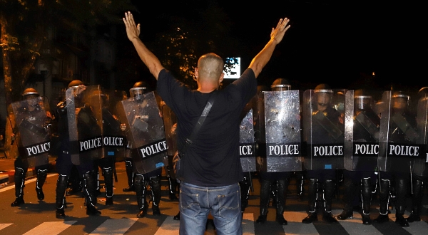 A pro-democracy protester gestures in front of riot police in Bangkok after the government declared a state of emergency. AFP A pro-democracy protester gestures in front of riot police in Bangkok after the government declared a state of emergency. AFP