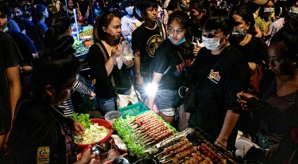 Grilled sausages, hotdogs, soups, cold drinks, pickled fruits and satay sticks are just some of the snacks on the menu. AFP
