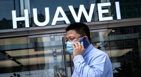 A man walks past a Huawei shop in Beijing.  AFP