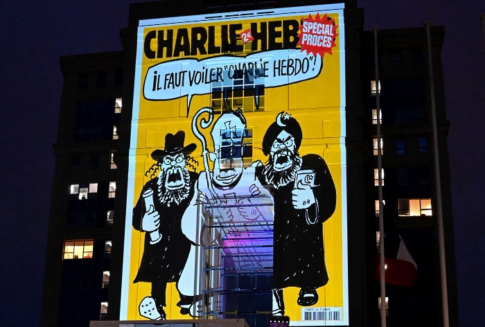 Cartoons of French satirical weekly newspaper Charlie Hebdo projected onto the façade of Hôtel de Région in Montpellier during a national homage to French teacher Samuel Paty who was beheaded for showing cartoons of Prophet Mohamed in his civics class.  AFP