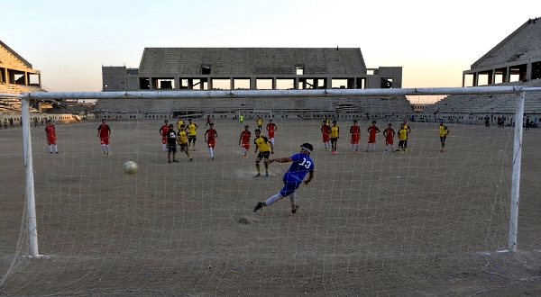 Players of Al-Mosul FC practice at the ravaged al-Idara al-Mahalia stadium. AFP