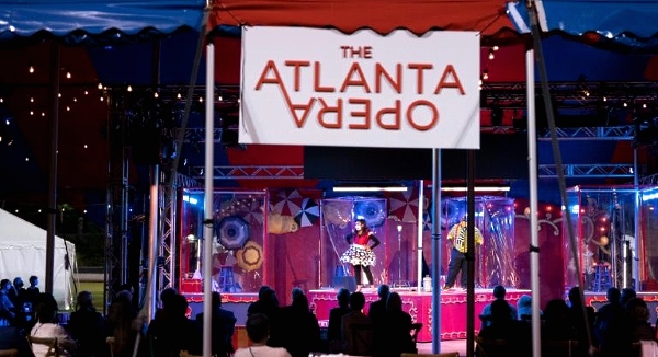 People perform in plastic boxes on stage during The Atlanta Opera's production of 