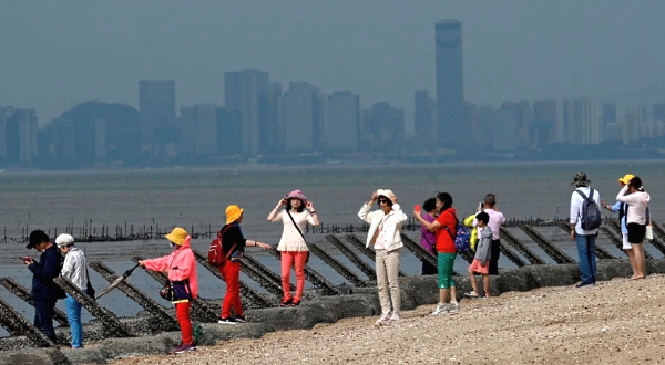 Tourists posing for photos next to anti-landing spikes placed along the coast of Taiwan's Quemoy islands just 3.2km from the mainland coast. AFP Tourists posing for photos next to anti-landing spikes placed along the coast of Taiwan's Quemoy islands just 3.2km from the mainland coast. AFP