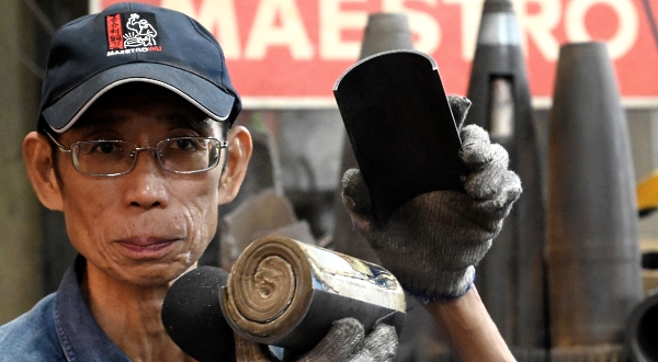 Wu Tseng-dong shows an artillery shell case containing communist Chinese propaganda fired decades ago from Xiamen. AFP Wu Tseng-dong shows an artillery shell case containing communist Chinese propaganda fired decades ago from Xiamen. AFP