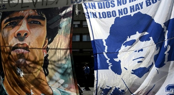 Flags of Diego Maradona outside the clinic in La Plata, where the club is based and the football star is receiving treatment. AFP